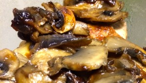 Closeup of pork chop smothered in caramelized onions and mushrooms.